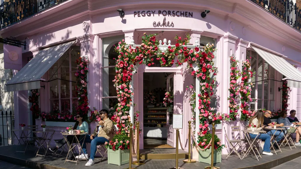 Peggy Porschen cafe exterior with flowers in an arch around the door