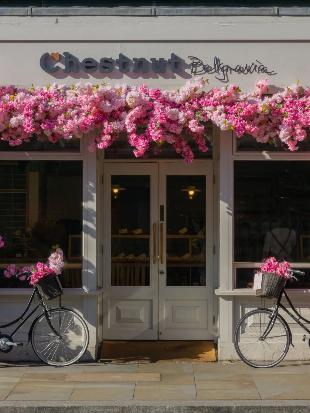 Outside of Chestnut Bakery surrounded with pink flowers