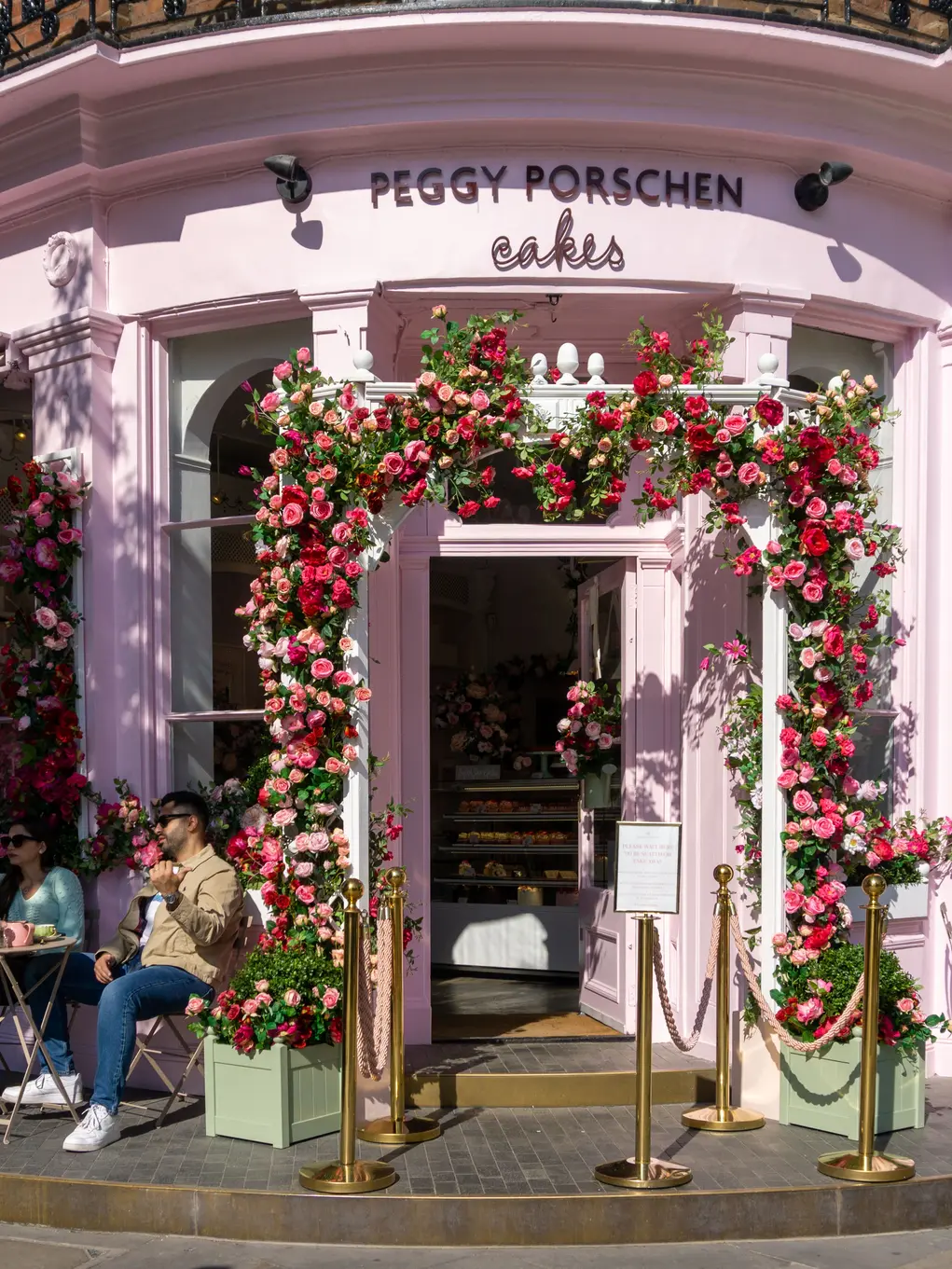 Peggy Porschen cafe exterior with flowers in an arch around the door