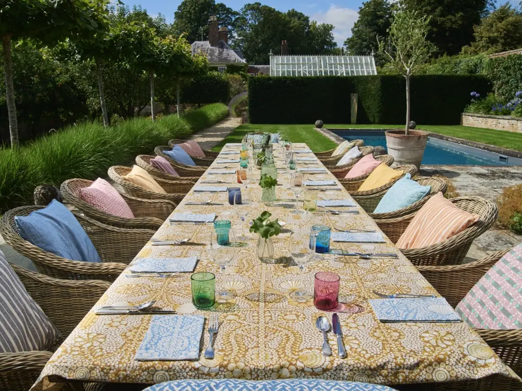 Long dining table and chairs in a garden