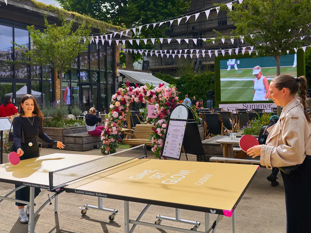 Two people play table tennis